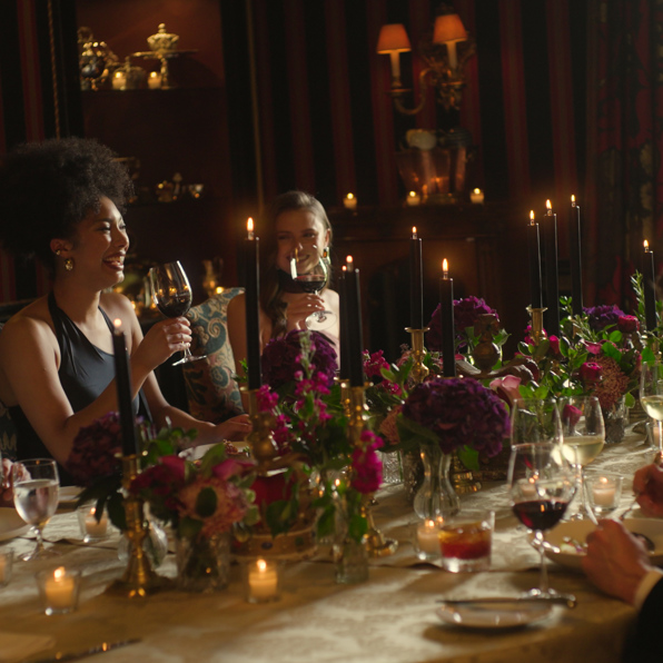 A group of guests enjoying a sophisticated dinner party in the Stuart private dining room at Prestonfield House, a 5-star luxury hotel in Edinburgh, renowned for providing some of the city's most exclusive private event spaces.