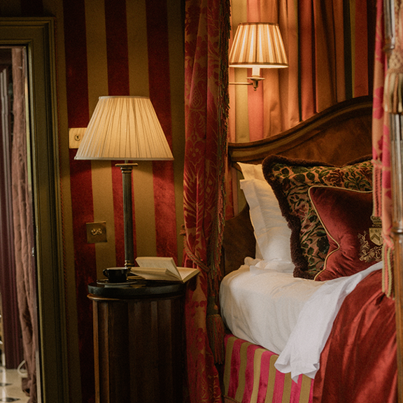 Lamps and book on bedside table beside 4 poster bed in the Owners Suite during luxury Edinburgh hotel deal stay