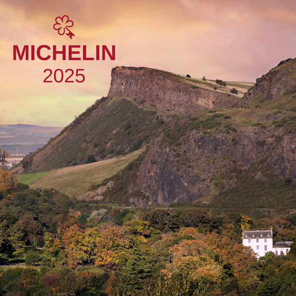 Prestonfield House beneath the iconic Salisbury Crags and autumn trees, with Michelin Key 2025 logo, an award for the best hotels in Edinburgh and the UK