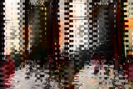 A grand dinner table set with candles and flowers in Prestonfield's Italian Room for large group private dining in Edinburgh 